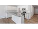 Bright kitchen with white cabinets, a granite countertop island, and modern stainless appliances at 112 Central Townes Way # 294, Raleigh, NC 27603