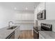 This bright kitchen features stainless steel appliances, granite countertops, white subway tile, and ample cabinet space at 112 Central Townes Way # 294, Raleigh, NC 27603