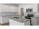 Updated kitchen featuring white cabinetry, stainless steel appliances, and granite countertops at 112 Central Townes Way # 294, Raleigh, NC 27603