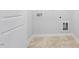 Bright laundry room featuring tile floors, washer and dryer hookups, and white trim at 112 Central Townes Way # 294, Raleigh, NC 27603