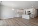 Open floor plan featuring hardwood floors, recessed lighting, and a modern kitchen with stainless steel appliances and an island at 112 Central Townes Way # 294, Raleigh, NC 27603