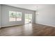 Bright and spacious living room features hardwood floors, a modern light fixture, and access to a large backyard at 112 Central Townes Way # 294, Raleigh, NC 27603