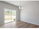 Bright room with hardwood floors, recessed lighting, and access to the backyard, offering a seamless indoor-outdoor living experience at 112 Central Townes Way # 294, Raleigh, NC 27603
