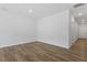 Unfurnished bedroom with neutral walls, recessed lighting, hardwood floors, and closet door at 116 Central Townes Way # 293, Raleigh, NC 27603