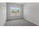 Bedroom with neutral walls, carpet, and a large window offering an outside view at 116 Central Townes Way # 293, Raleigh, NC 27603