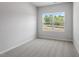 Bedroom with neutral walls, carpet, and a large window offering an outside view at 116 Central Townes Way # 293, Raleigh, NC 27603