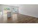 Sunlit dining area features hardwood floors, a modern chandelier, and large windows with views of the backyard at 116 Central Townes Way # 293, Raleigh, NC 27603