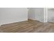 Hallway with hardwood floors, white walls, neutral trim, and white doors at 116 Central Townes Way # 293, Raleigh, NC 27603