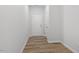 Bright hallway with white walls, light-colored floors, and a white door with chrome hardware at 116 Central Townes Way # 293, Raleigh, NC 27603