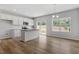 Open kitchen featuring stainless appliances, island, white cabinets, and natural lighting at 116 Central Townes Way # 293, Raleigh, NC 27603