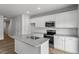 Kitchen with stainless appliances, center island with a sink, and white cabinets at 116 Central Townes Way # 293, Raleigh, NC 27603