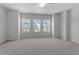 Spacious main bedroom featuring neutral walls, carpet floors, and large windows letting in ample natural light at 116 Central Townes Way # 293, Raleigh, NC 27603