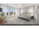 Sun-filled main bedroom with large windows, neutral walls, and a ceiling fan at 116 Central Townes Way # 293, Raleigh, NC 27603