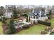 Aerial view of a luxury home with a swimming pool, manicured lawn, and verdant foliage at 12132 Lockhart Ln, Raleigh, NC 27614