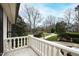 Outdoor balcony area boasting stately white columns and green outdoor scenery at 12132 Lockhart Ln, Raleigh, NC 27614