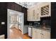 The bar area features custom cabinets, granite countertops, a wine rack, and a beverage refrigerator at 12132 Lockhart Ln, Raleigh, NC 27614