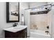 Elegant bathroom featuring a marble countertop vanity and tiled shower with decorative accents at 12132 Lockhart Ln, Raleigh, NC 27614