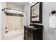 Classic bathroom featuring a dark vanity cabinet, marble countertop, and beautifully tiled shower/tub at 12132 Lockhart Ln, Raleigh, NC 27614