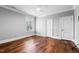 Spacious bedroom with hardwood floors, neutral paint, and bright window at 12132 Lockhart Ln, Raleigh, NC 27614