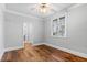 Bright bedroom featuring hardwood floors, neutral paint, and crown molding at 12132 Lockhart Ln, Raleigh, NC 27614