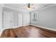 Empty bedroom with hardwood floors, two access doors, and a window at 12132 Lockhart Ln, Raleigh, NC 27614