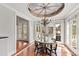Sunny breakfast nook boasts floor-to-ceiling windows and access to the outdoor living area at 12132 Lockhart Ln, Raleigh, NC 27614