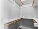 Walk-in closet featuring built-in shelving and wooden rods for optimal storage and organization at 12132 Lockhart Ln, Raleigh, NC 27614