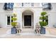 Elegant entrance with double doors, lion statues, and manicured greenery at 12132 Lockhart Ln, Raleigh, NC 27614