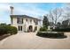 Elegant two-story home with a circular driveway, manicured landscaping, and charming architectural details at 12132 Lockhart Ln, Raleigh, NC 27614