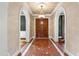 A grand foyer with arched doorways, a decorative chandelier, and a meticulously patterned floor at 12132 Lockhart Ln, Raleigh, NC 27614