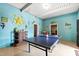 Fun game room featuring a ping pong table, fun decorations, and a back door at 12132 Lockhart Ln, Raleigh, NC 27614