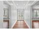 Inviting hallway with hardwood floors and double doors to the outside at 12132 Lockhart Ln, Raleigh, NC 27614