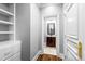 Hallway leading to an elegant bathroom with a classic vanity at 12132 Lockhart Ln, Raleigh, NC 27614