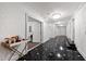 Long hallway showcasing marble floors, bright lighting, and several closed doors at the end at 12132 Lockhart Ln, Raleigh, NC 27614