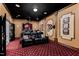 A luxurious home theater featuring comfortable leather seating, classic decor, and a projector for immersive entertainment at 12132 Lockhart Ln, Raleigh, NC 27614
