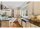 Kitchen featuring granite countertops, designer fixtures, and custom cabinetry at 12132 Lockhart Ln, Raleigh, NC 27614