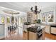 Bright kitchen with an island, tile floors, and views to the breakfast nook and backyard at 12132 Lockhart Ln, Raleigh, NC 27614