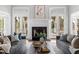 Comfortable living room with a fireplace, French doors, and cozy sofas at 12132 Lockhart Ln, Raleigh, NC 27614
