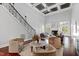 Spacious living room featuring coffered ceilings, grand staircase, and stylish seating at 12132 Lockhart Ln, Raleigh, NC 27614