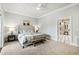 The main bedroom offers carpet floors, a ceiling fan, and doorway leading to an ensuite bathroom and walk-in closet at 12132 Lockhart Ln, Raleigh, NC 27614