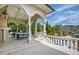 Scenic outdoor patio features elegant columns, comfortable seating, and a serene water view at 12132 Lockhart Ln, Raleigh, NC 27614