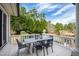 Open-air patio with travertine tile, outdoor dining and a tranquil view at 12132 Lockhart Ln, Raleigh, NC 27614