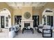 Comfortable outdoor patio boasts a fireplace, ample seating and a decorative ceiling at 12132 Lockhart Ln, Raleigh, NC 27614