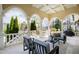 Charming outdoor patio has comfortable seating, decorative columns, and manicured landscaping at 12132 Lockhart Ln, Raleigh, NC 27614