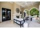 Inviting outdoor patio features a fireplace, comfortable seating, and double French doors at 12132 Lockhart Ln, Raleigh, NC 27614