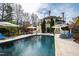 Private pool area with elegant lounge chairs, and well-manicured landscaping at 12132 Lockhart Ln, Raleigh, NC 27614