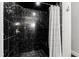Beautiful shower featuring black marble, gold hardware, and a shower curtain at 12132 Lockhart Ln, Raleigh, NC 27614