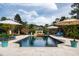 Refreshing in-ground pool with a raised water feature, lush landscaping, and inviting lounge chairs at 12132 Lockhart Ln, Raleigh, NC 27614