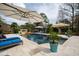 Resort-style pool with a raised waterfall, lounge chairs, and tropical landscaping at 12132 Lockhart Ln, Raleigh, NC 27614