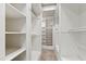 Spacious walk-in closet boasts built-in shelving, rods and storage with neutral carpeting at 12132 Lockhart Ln, Raleigh, NC 27614
